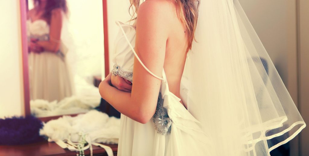 Bride getting dressed - 12 photos you'll regret not taking on your wedding day - The Wedding Club