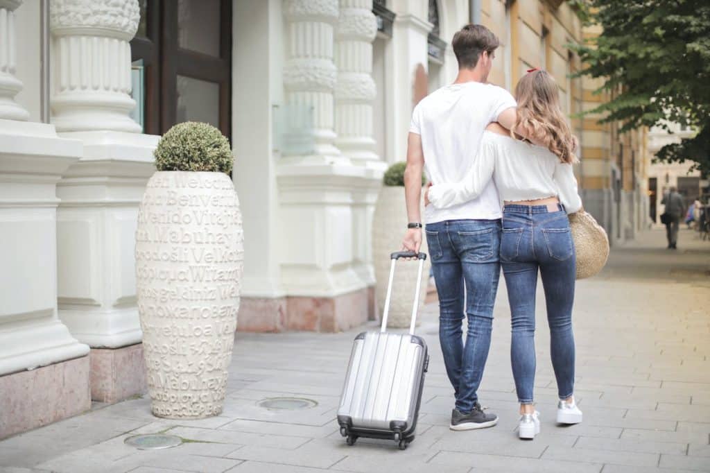 Photo by Andrea Piacquadio: https://www.pexels.com/photo/couple-with-suitcase-walking-along-city-street-3756158/