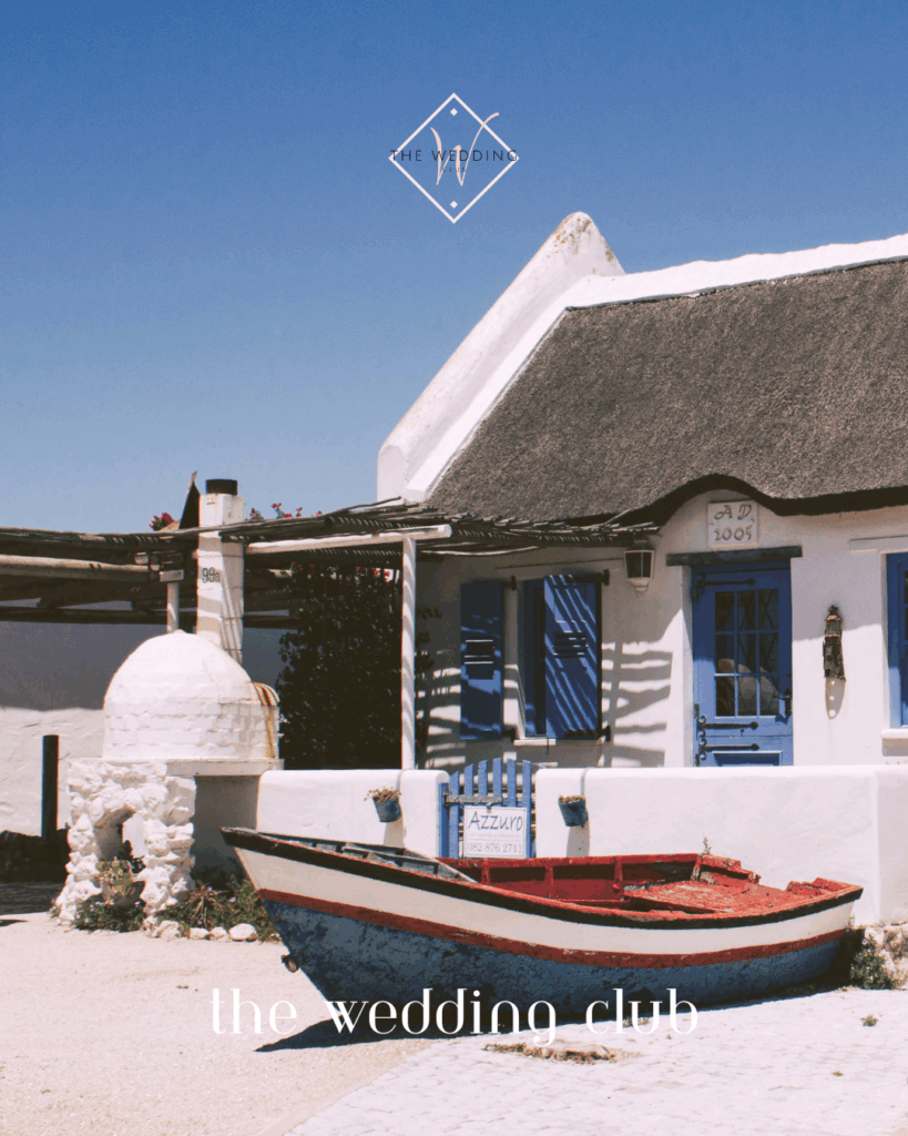 Affordable honeymoon idea in Paternoster, South Africa – charming coastal village with whitewashed cottages and blue accents.