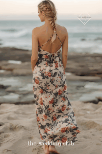 Loose fishtail braid over one shoulder, floral maxi dress, barefoot guest look, beach ceremony with ocean view